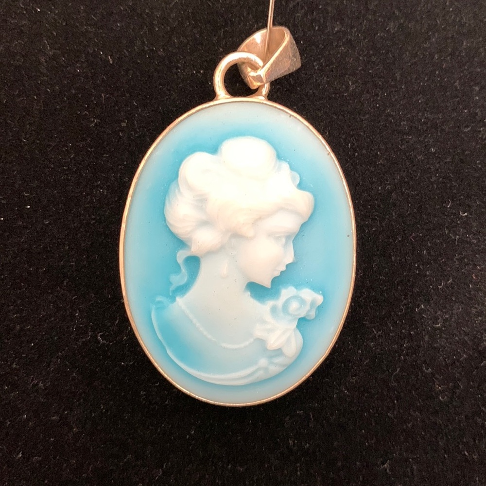 Suite, pendant & French wire earrings- blue Cameos facing their left.